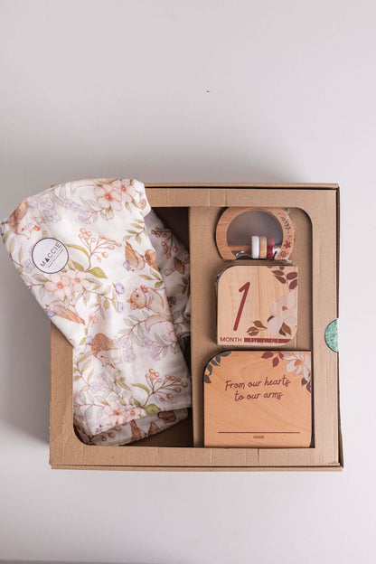 Baby Gift Set including Maccie swaddle, milestone disks, and rattle beautifully presented in a gift box.