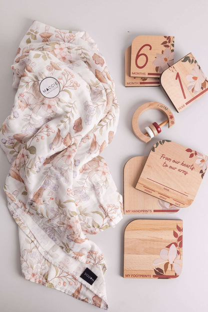 Baby Gift Set featuring Maccie Swaddle, milestone disks, wooden rattle, and crafted designs.