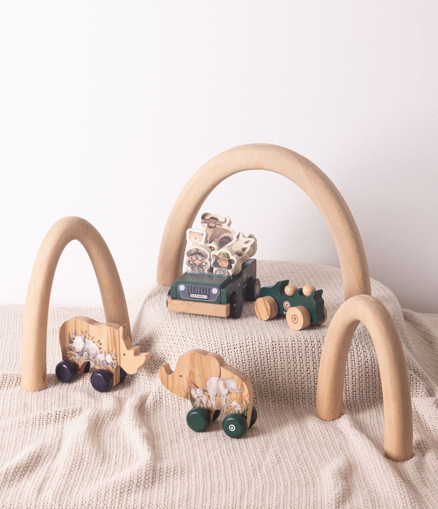 Wooden toy play set featuring safari animals, vehicles, and arches for imaginative play and adventure.