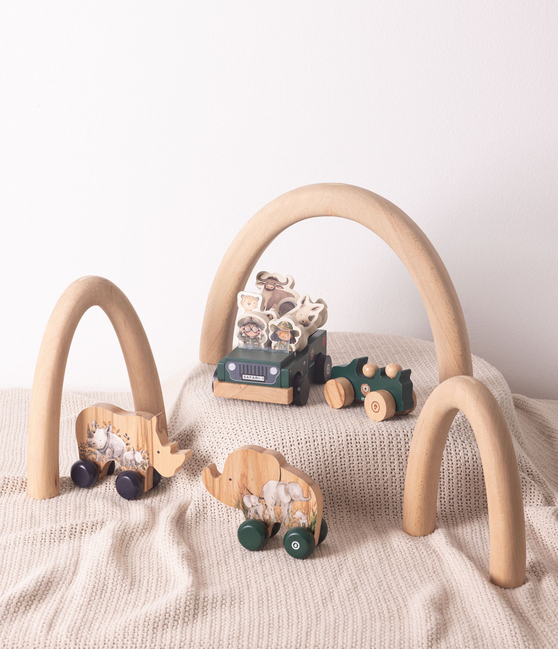 Wooden toy play set featuring safari animals, vehicles, and arches for imaginative play and adventure.